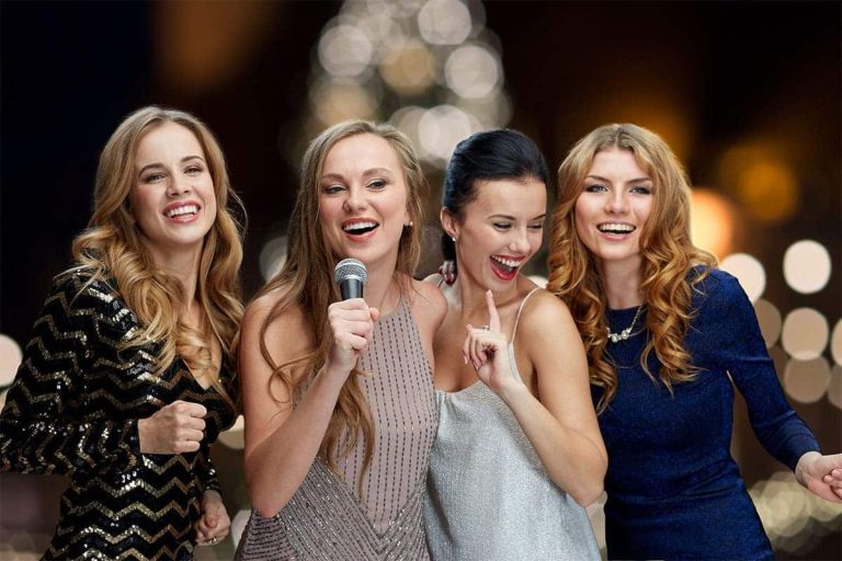 women with microphone singing karaoke