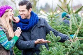 Man and won choosing a christmas tree - christmas.co.uk