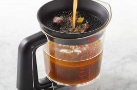 Pic of meat juices being poured into a gravy separator - Two types of fat separator