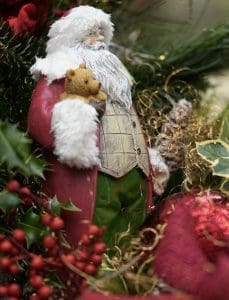Pic of Santa and teddy in a tree - part of a Christmas survival guide 