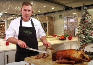 pic of a chef about to carve a roasted goose