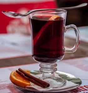 pic of a glass of mulled wine with orange and cinnamon