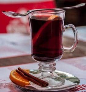 pic of a glass of mulled wine with orange and cinnamon