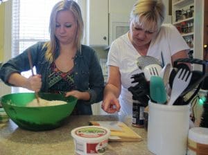Pic of two women working hard on stir up sunday.