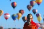 Pic of a child looking at hot air balloons to illustrate a story about unusual Xmas gifts - hot air air balloon rides as a Christmas present