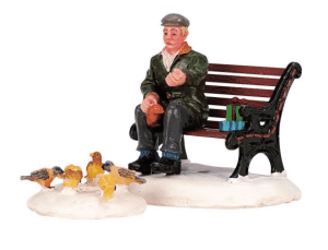 Lemax Caddington village figurine of a man sitting on a bench feeding pigeons