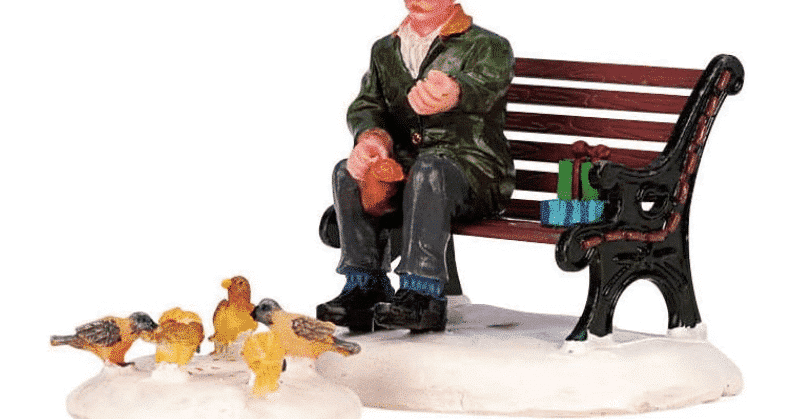 Lemax Caddington village figurine of a man sitting on a bench feeding pigeons