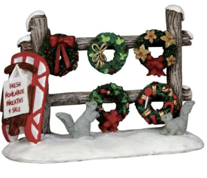 Lemax Caddington Village Christmas wreaths christmas co uk Lemax Caddington Village Christmas wreaths on a fence with a sled