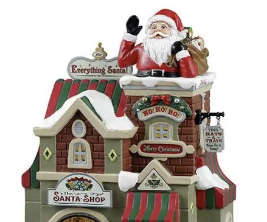 Lemax Caddington Village Santa shop with Santa emerging from the chimney on the snow covered roof
